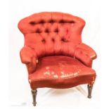 A Victorian button back armchair with serpentine form front.