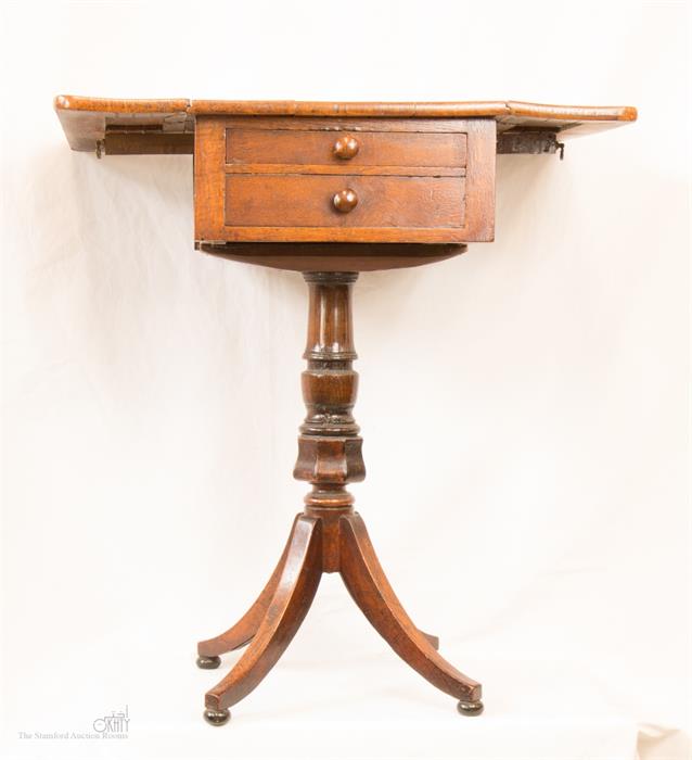 A 19th century oak work table with two drawers, turned column and four splayed legs.