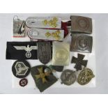 A group of German military badges, belt buckles etc.