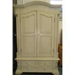 A white French style painted wardrobe with drawers below.