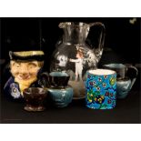 A pair of blue glazed stoneware jugs, a toby jug, an agate egg cup and a German glass jug painted