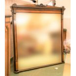 A Victorian walnut veneered and ebonised mirror.