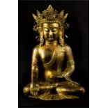 A bronze Buddhist deity, with some original gilding and paintwork, serene pose.