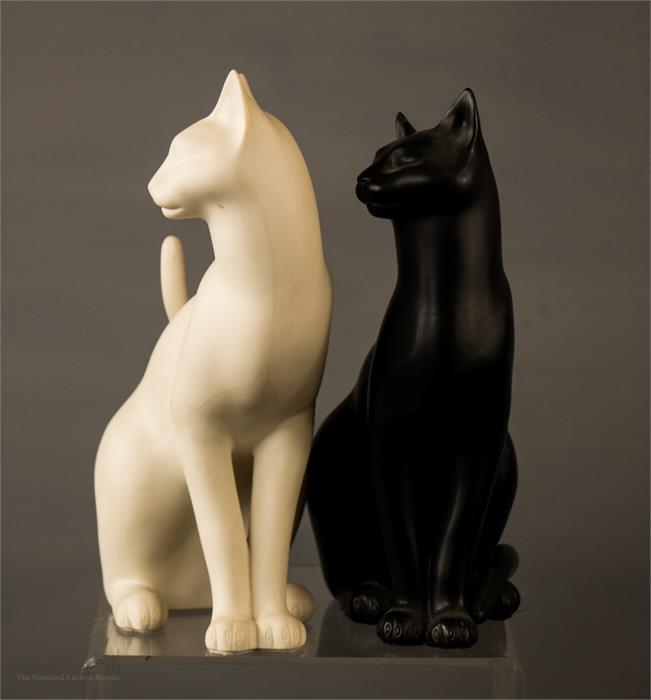 A pair of Franklin Mint porcelain cats, one black and one white, labelled to the bases.