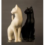 A pair of Franklin Mint porcelain cats, one black and one white, labelled to the bases.