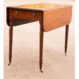 A Regency mahogany Pembroke table with two drop leaves and single drawer, raised on turned legs.