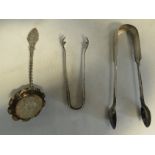 A pair of silver sugar tongs, sugar nips and a sifter, 3toz.