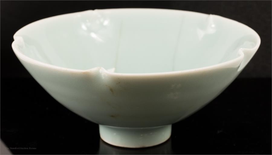 A blue Chinese crackleglazed celadon bowl.