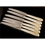 A set of six silver handled side knives.