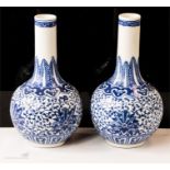 A pair of blue and white bottle vases with seal mark underside.