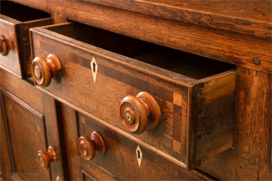 A Georgian oak dresser, the enclosed rack with three shelves above drawers inlaid with decoration. - Image 8 of 9