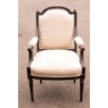 An Edwardian cream upholstered armchair.