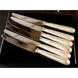 A set of six silver handled dinner knives.