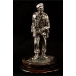 A silvered metal figure of a soldier.