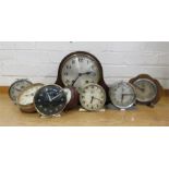 A quantity of clocks, including alarm clocks and mantle clock.