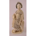 A Japanese ivory okimono of a Geisha girl, signed to the base.