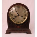 A mahogany mantle clock with Arabic dial.