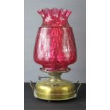 A cranberry glass 'pineapple' shaped parafin lamp.