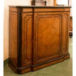 A Victorian cabinet, the veneered and ebonised door flanked by rounded corners.