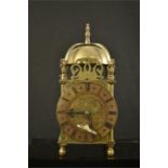 A 17th century style miniature brass bracket clock and key.