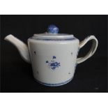 A blue and white porcelain tea pot with cross over handle.