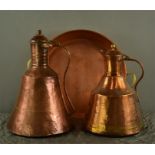 A pair of copper middle eastern water carriers, together with a copper pan.