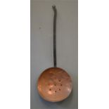 An early copper skillet with iron handle.