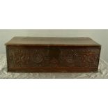 A 17th century oak bible box with fret carved front, 33 by 65 by 20cm.