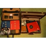 Two briefcases containing coins, including English and worldwide, coin year book and other coins.