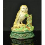 A small cast iron painted doorstop in the form of an owl.