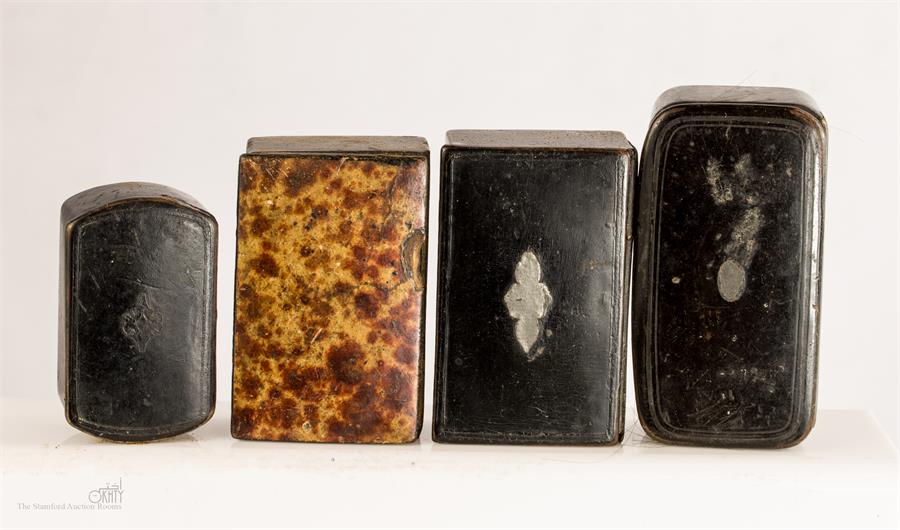 A group of four 19th century papier mache snuff boxes.