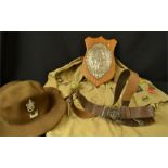 A group of Boy Scouts collectables, hat, plaque, belt, shirt all with original cloth badges.