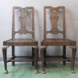 A pair of carved oak chairs, with carved splats.