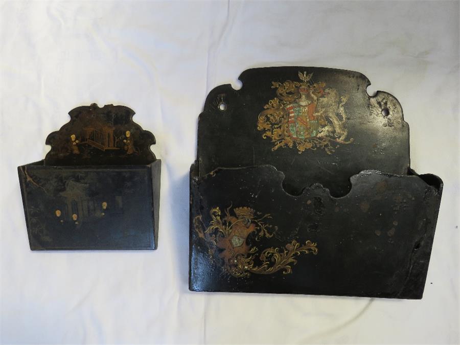 Two papier mache letter racks, painted with decoration; one small with chinoiserie scene, the larger