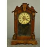 A mantle clock, veneered, TH papered to the back.