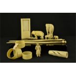 A group of bone carvings including Victorian napkin rings, lion figure, 19th century elephant,