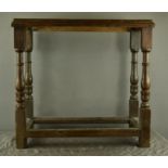 A small 18th century oak side table, with turned legs and plank top, 78 by 34 by 64cm.