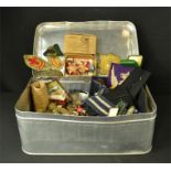A large tin of badges, WWII medals to include Burma Star, Boy Scouts badges, etc.