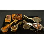A group of tortoiseshell miniature instruments, including guitar, mandolins, snuff box etc.
