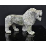 A stone carved lion, 10cm high.