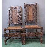 Two Carolean walnut chairs, with caned seats, both carved with cherubs and scrollwork.