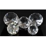 A group of glass and perspex diamond form paperweights.