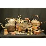 A group of copper ware to include a kettles, candlesticks, jars etc.