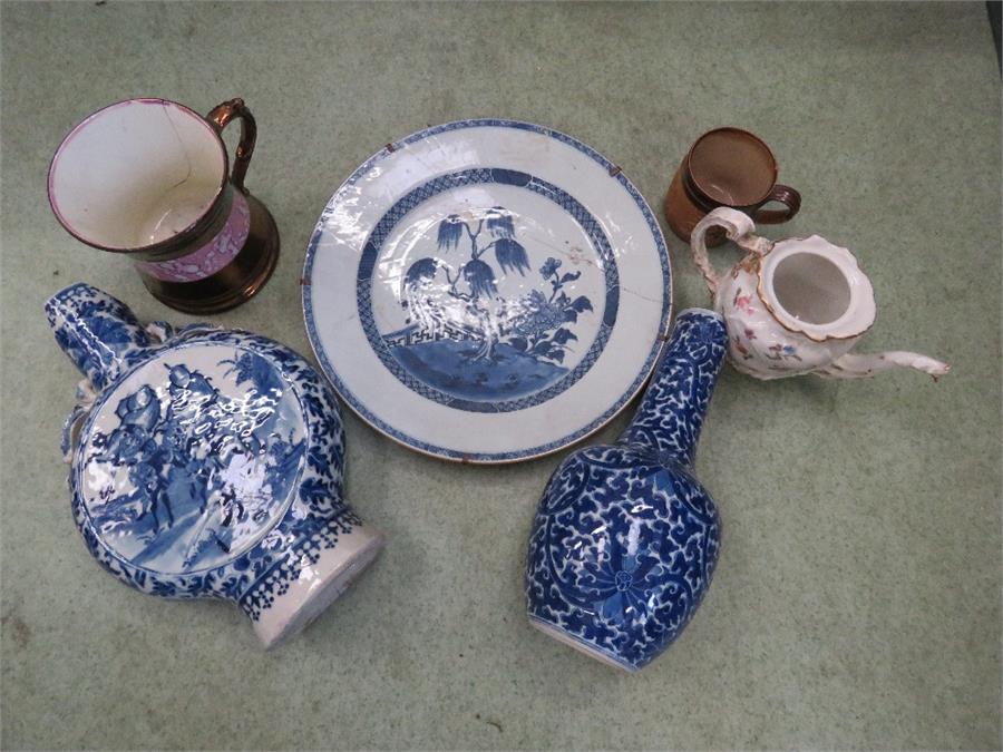 A group of ceramics including a blue and white moon flask, bottle vase, Delft charger, Victorian