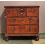 An 18th century walnut chest of drawers, with three short and three long graduated drawers, raised