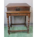 A 17th century oak bible box on later stand, with fret carved front panel, the stand with turned