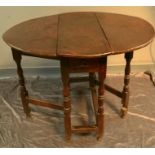 A 17th century oak gateleg table of small proportions, with a single drawer, turned legs and