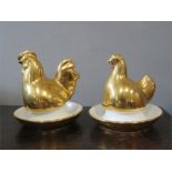 A pair of hen and cockerel egg cups and covers.