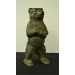 A brass money box modelled as a bear.