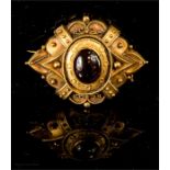 A 19th century yellow metal mourning brooch, with cobochan garnet to the centre.